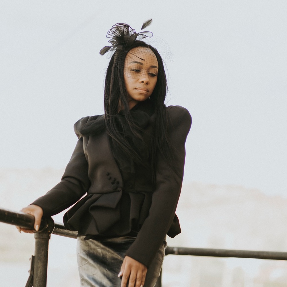 Elegant Black Peplum Jacket with Fascinator